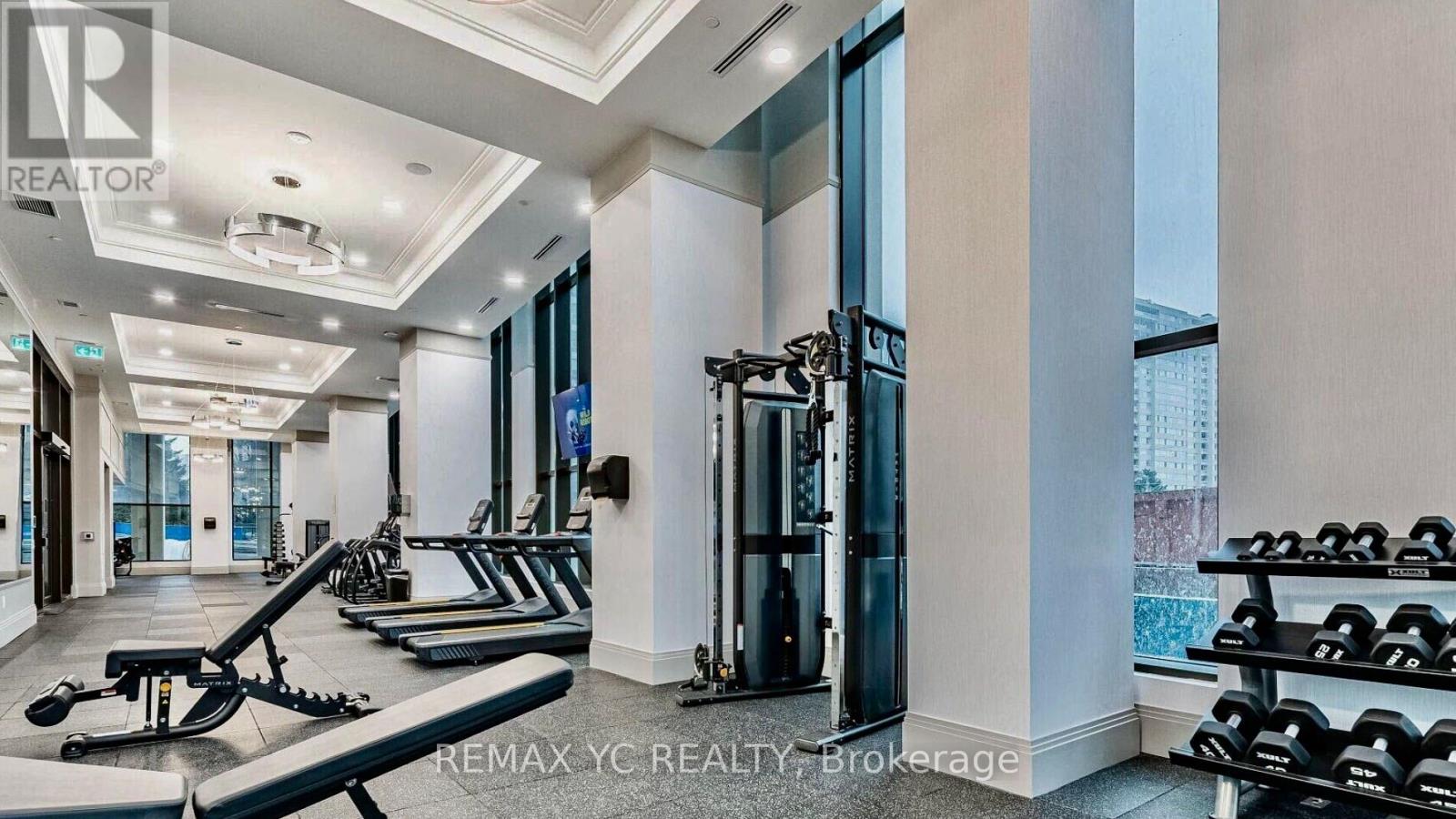 A well-lit gym with a variety of equipment including treadmills, weights, and exercise machines.