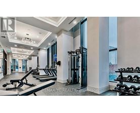 A well-lit gym with a variety of equipment including treadmills, weights, and exercise machines.