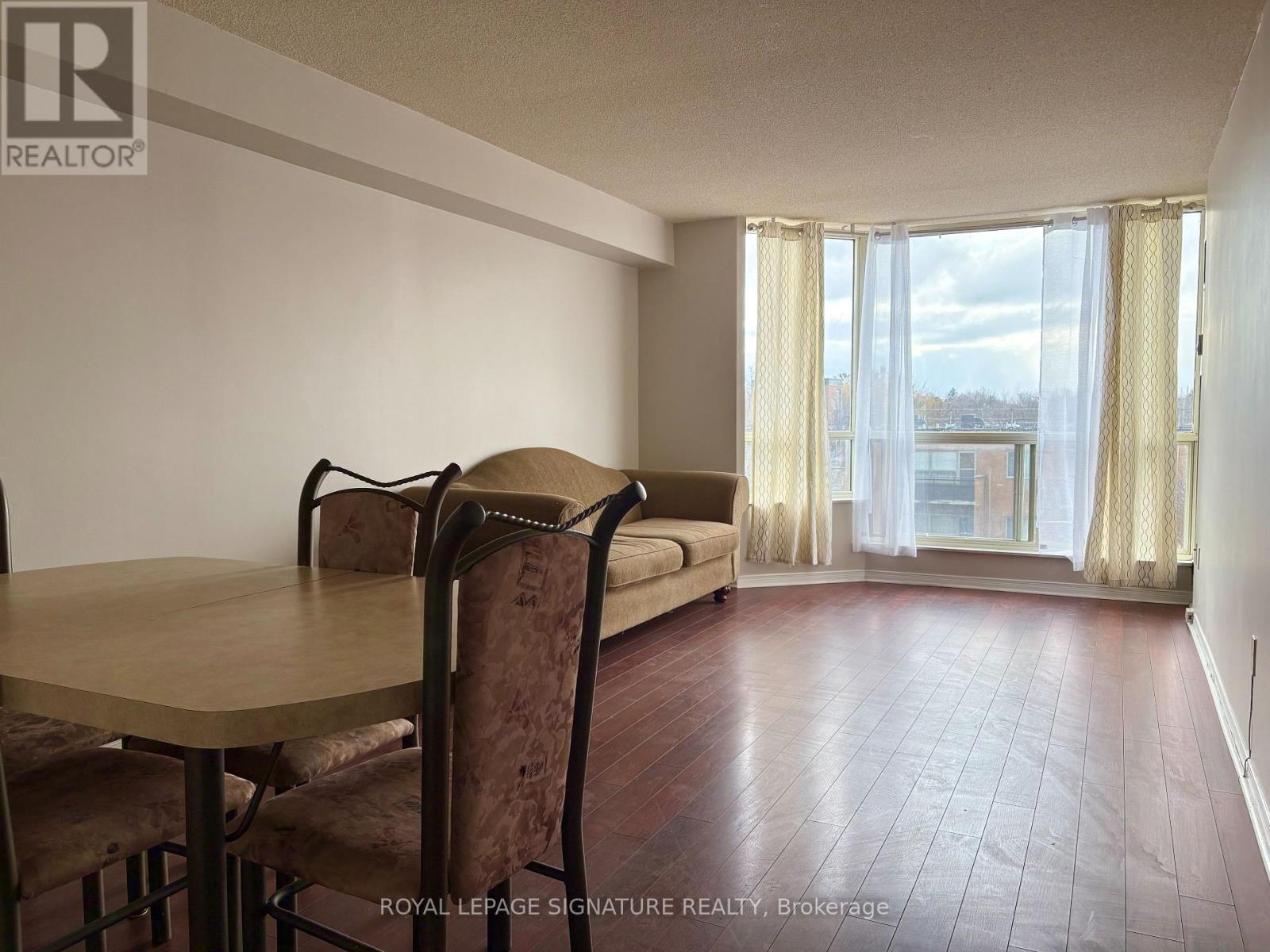 A dining room with a table and chairs is shown.