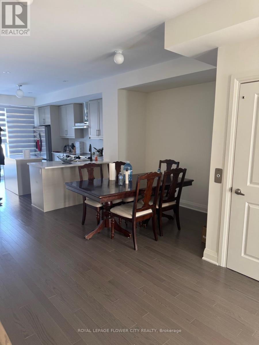 A dining room with a table and chairs.