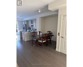 A dining room with a table and chairs.