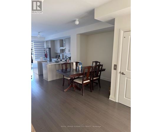 A dining room with a table and chairs.