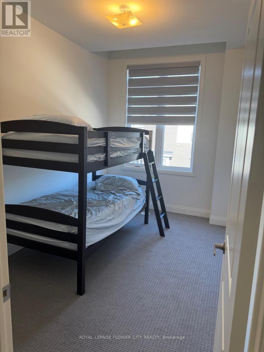 A bedroom with a bunk bed and a window with blinds.