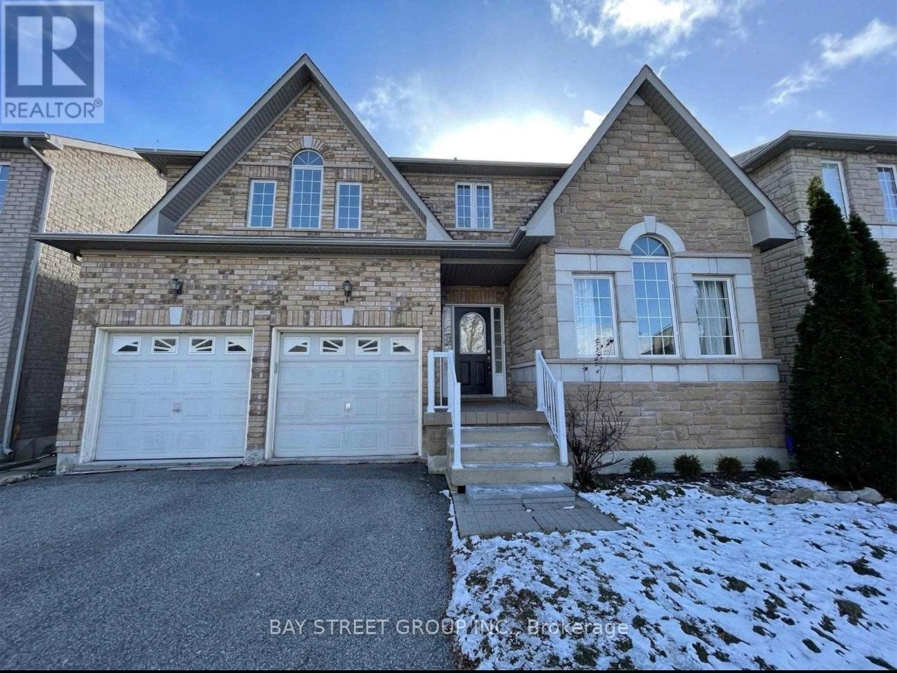 A large house with a driveway in front of it.