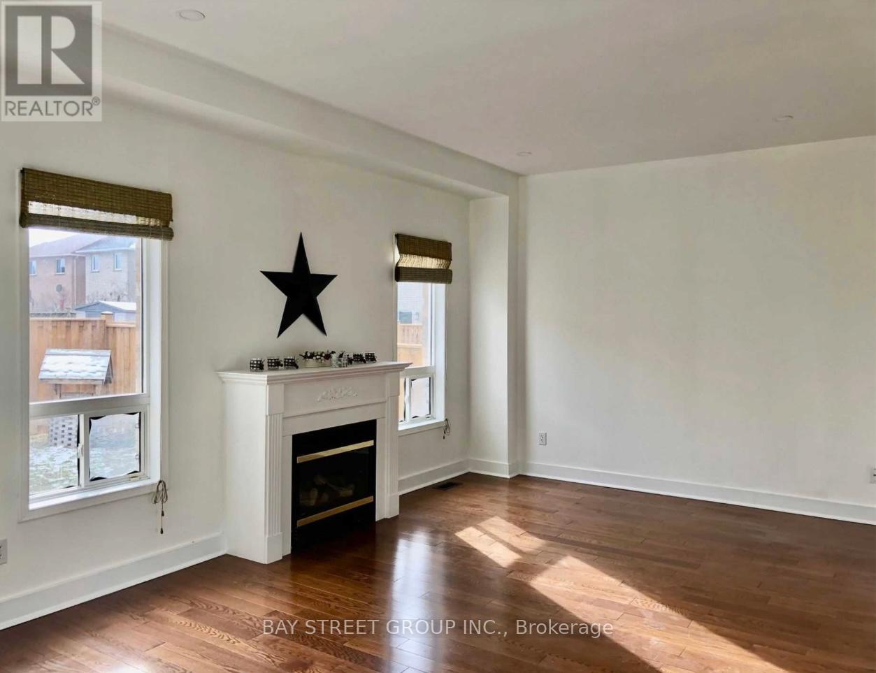 A room with a fireplace and a star decoration on the wall.