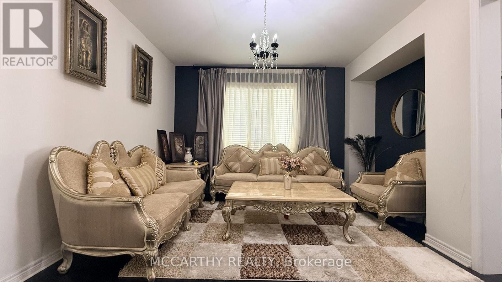 A living room with a beige sofa and a coffee table.