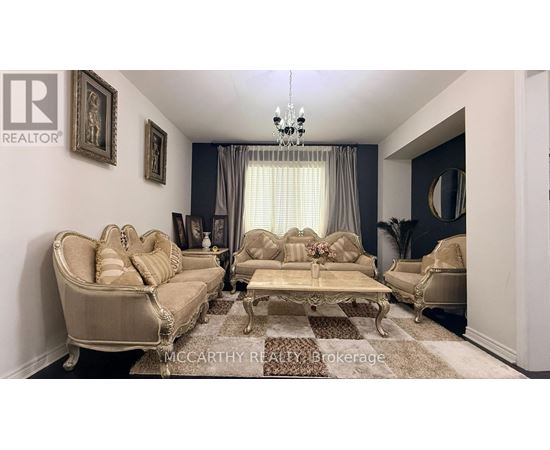 A living room with a beige sofa and a coffee table.