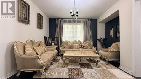 A living room with a beige sofa and a coffee table.