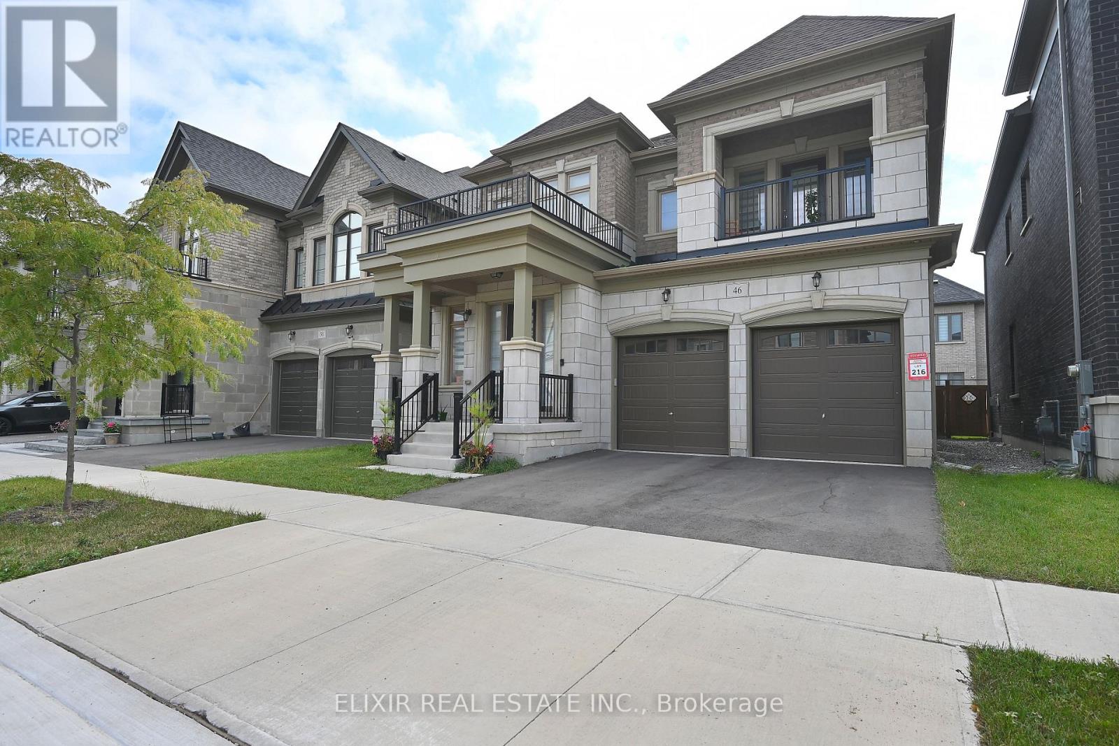 A large, two-story house with a garage is for sale.
