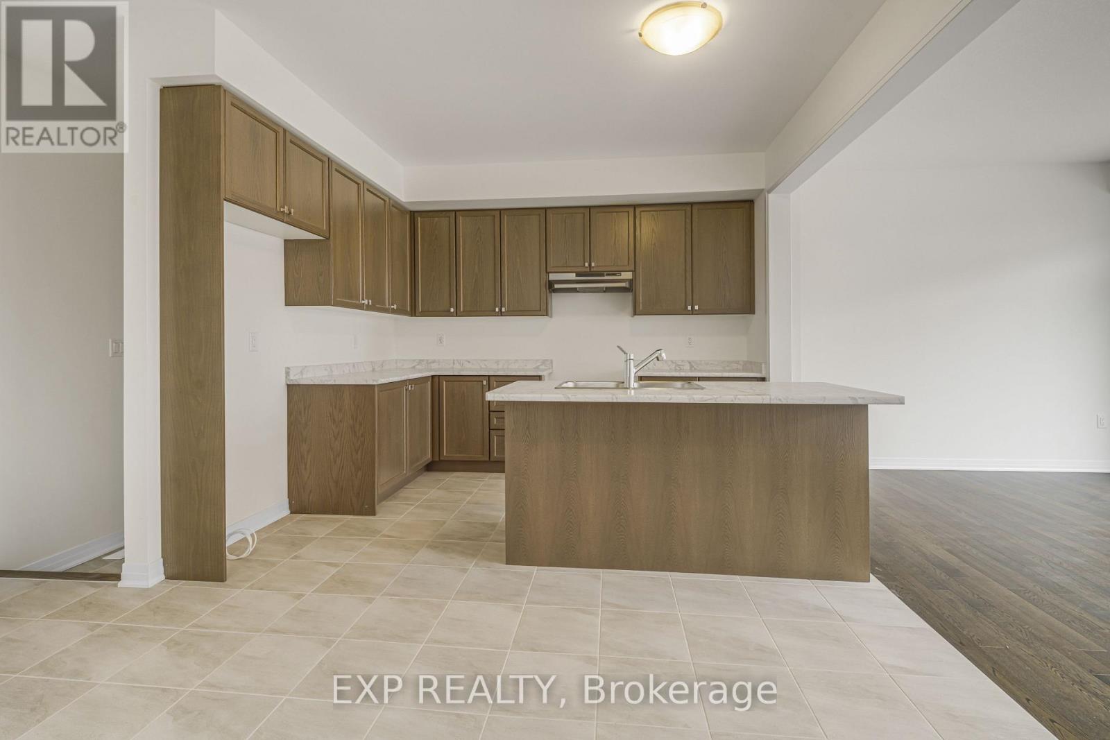A kitchen with brown cabinets and a white countertop.
