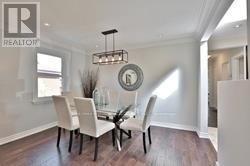 A dining room with a table and chairs.