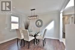 A dining room with a table and chairs.