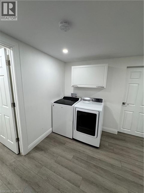A white microwave oven and a white toaster oven are on a counter in a kitchen.