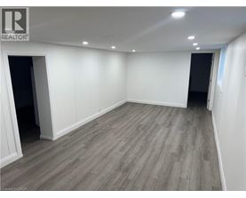 A room with wooden flooring and white walls.