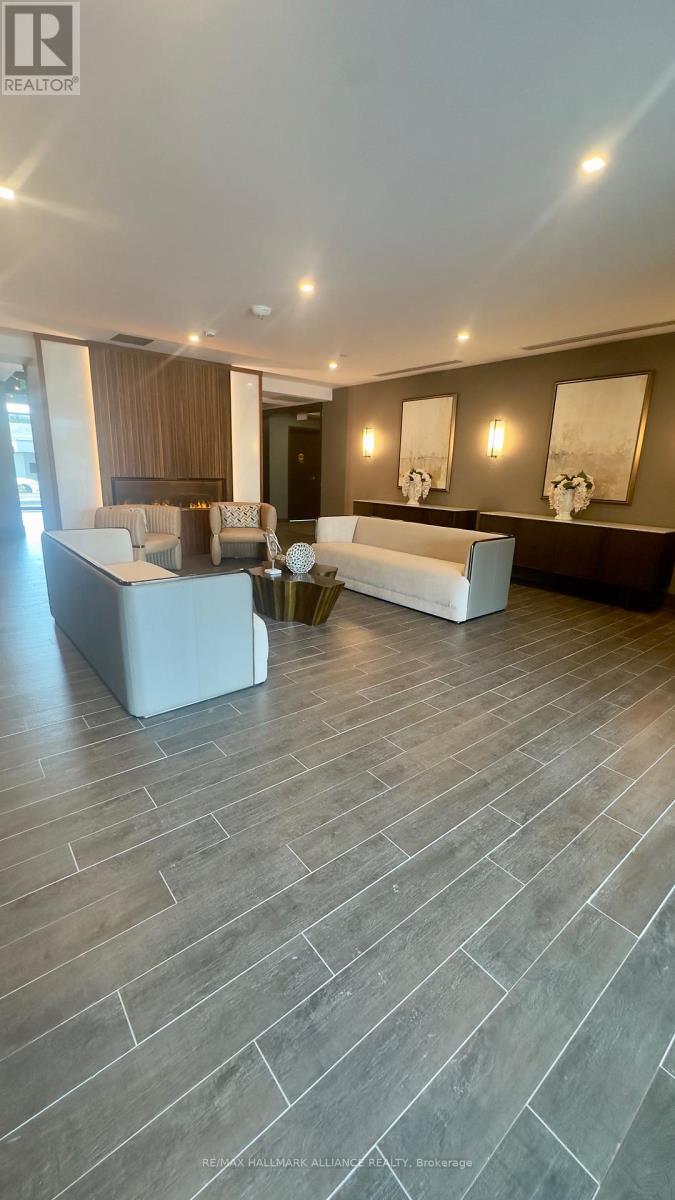 A spacious living room with a grey floor and a white sofa.