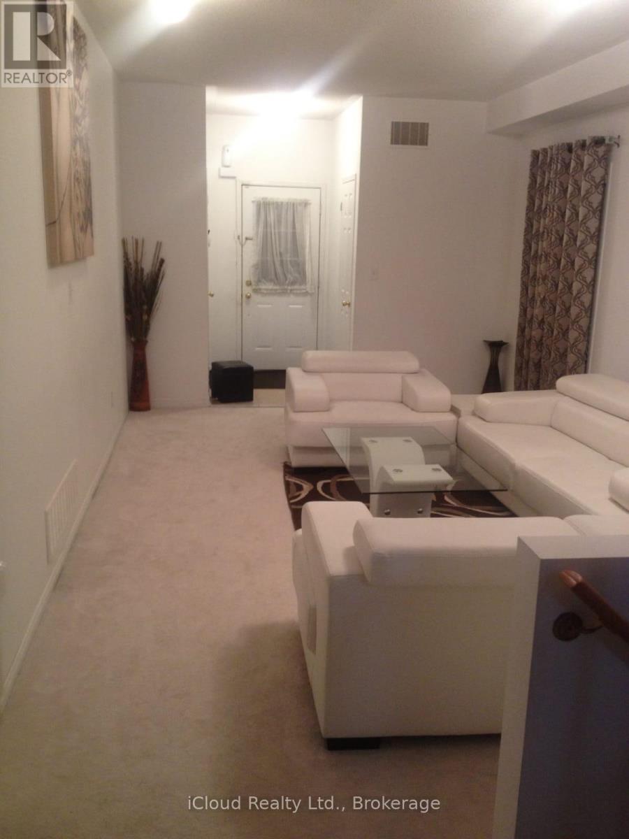 A white couch in a room with a door in the background.