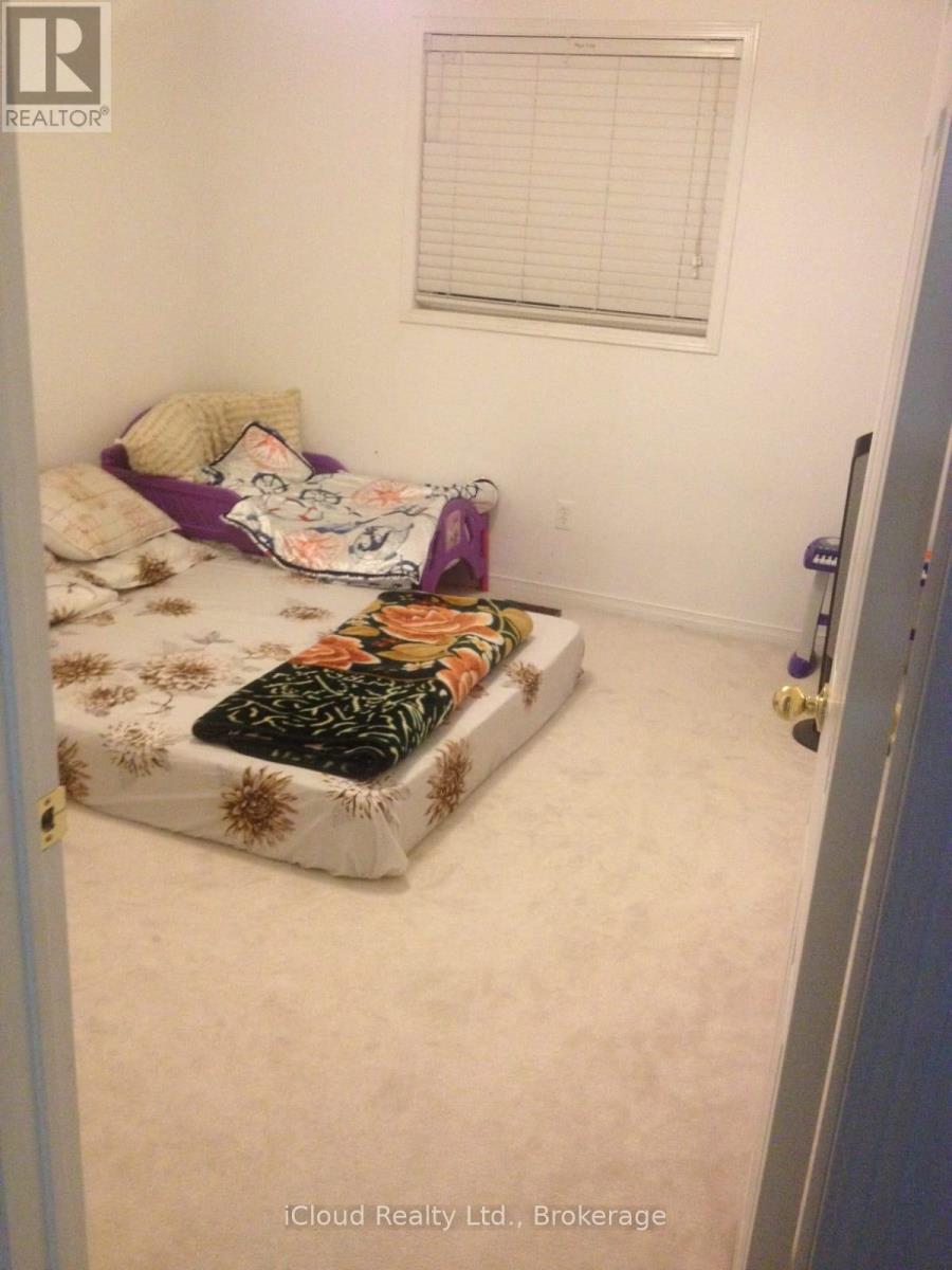A bedroom with a bed and a window.