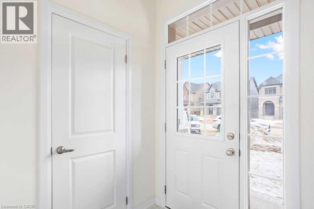 A white door with a glass window showing a snowy landscape.