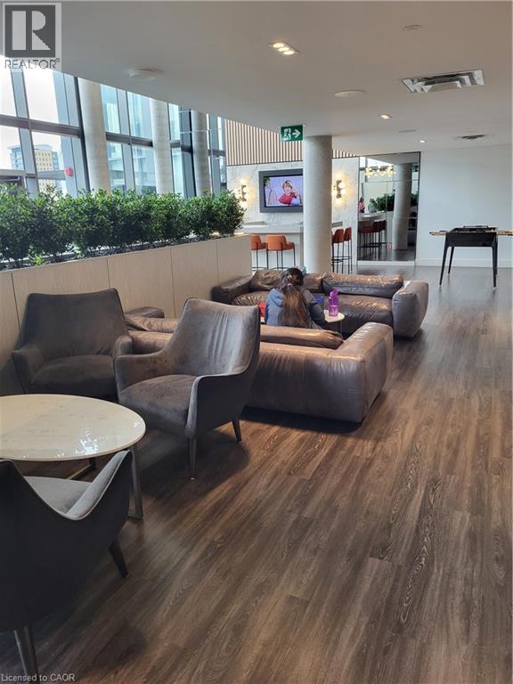 A living room with a couch, chairs, and a table.