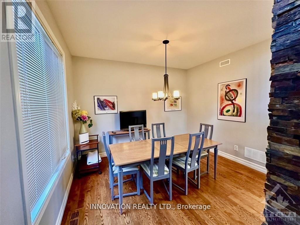 A dining room with a wooden table and chairs.