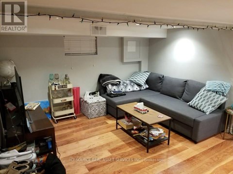 A living room with a grey couch and a coffee table.