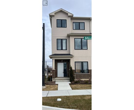 A two-story beige house with a white door and a green street sign that says "BALL".