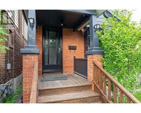 A house numbered 97 has a black front door and a wooden porch.