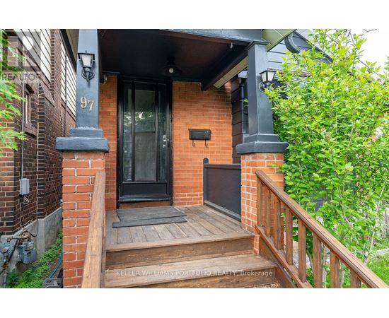 A house numbered 97 has a black front door and a wooden porch.