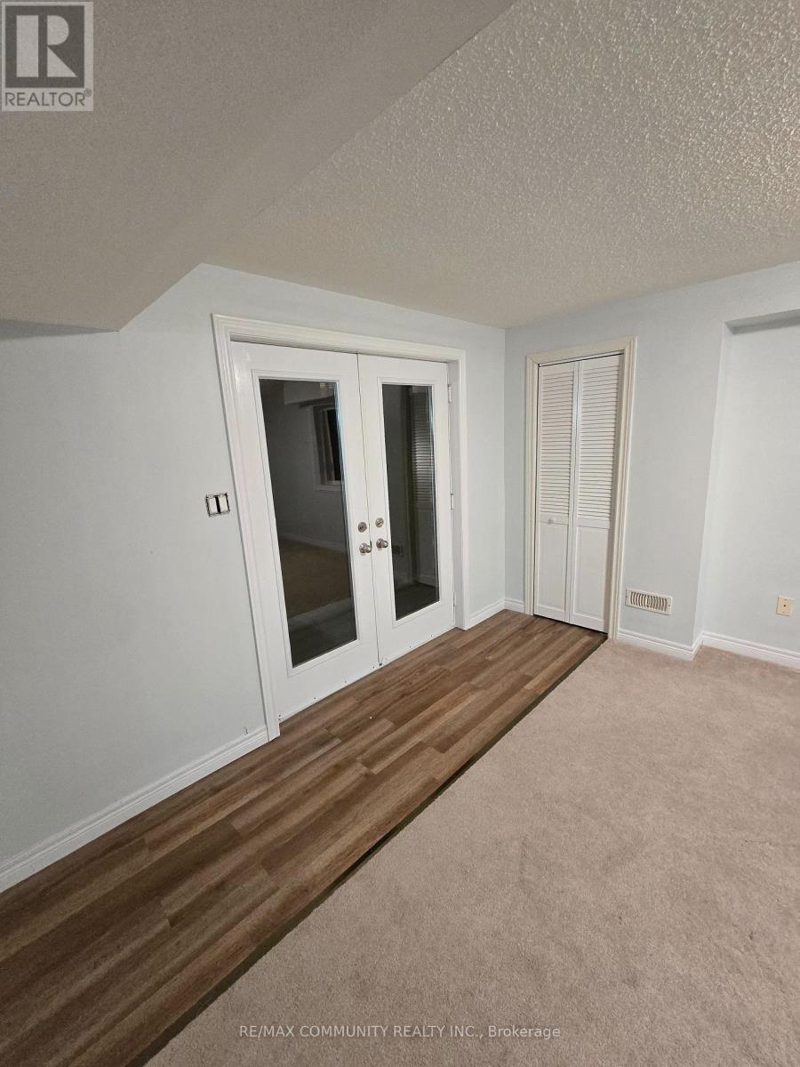 A room with a white door and a window with blinds.