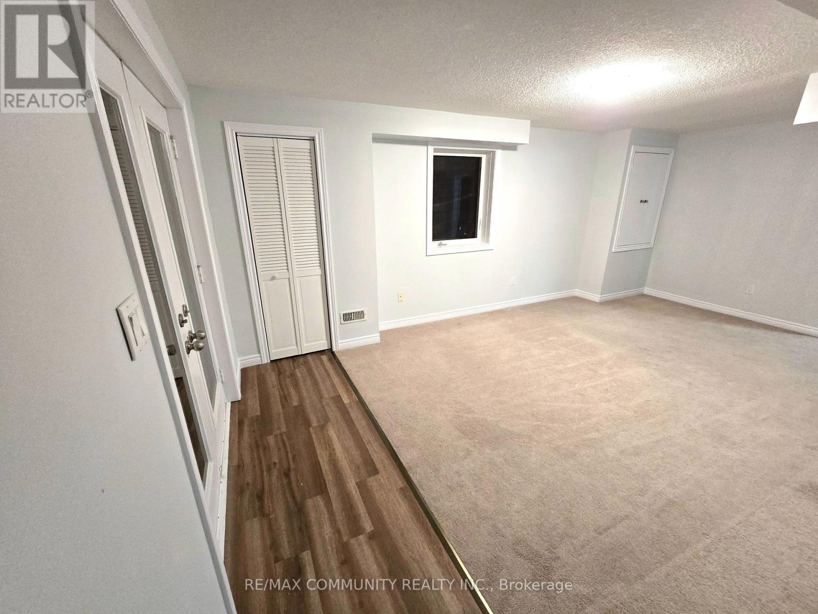 A room with a window and a door is available for rent.
