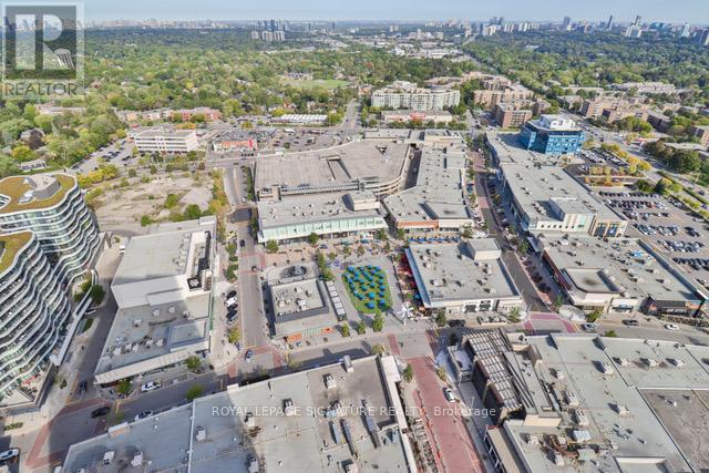 An aerial view of a city with a mix of buildings and green spaces.