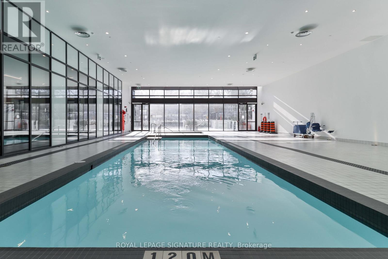 A large indoor swimming pool with the number 12.00m marked on the side.