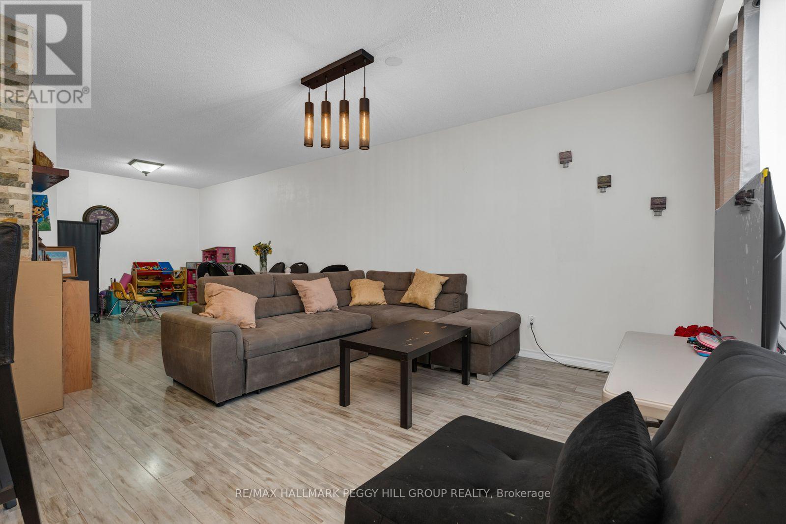 A living room with a grey couch and a wooden coffee table.