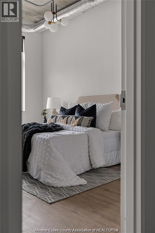 A bedroom with a bed and a lamp.