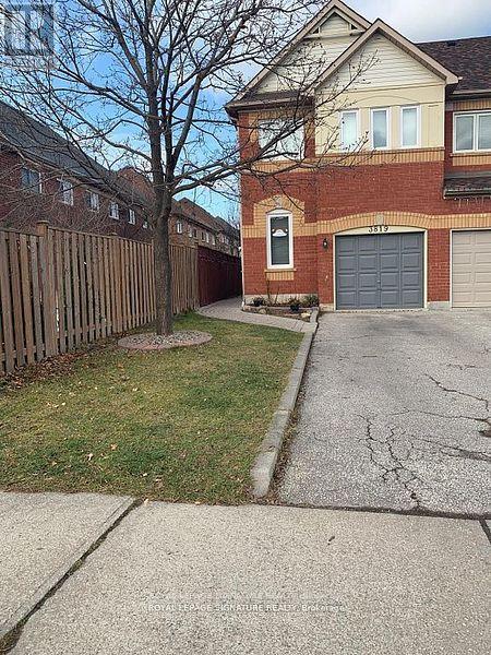 A house with a garage and a driveway in front.