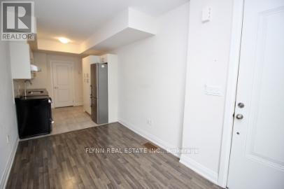 A room with a white door and a white wall.