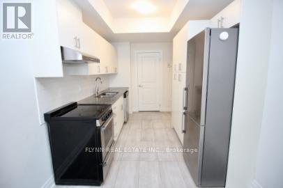 A kitchen with white cabinets and a black stove top oven.
