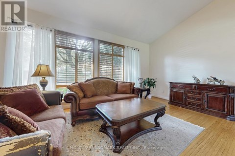 A living room with a brown couch and a wooden coffee table.