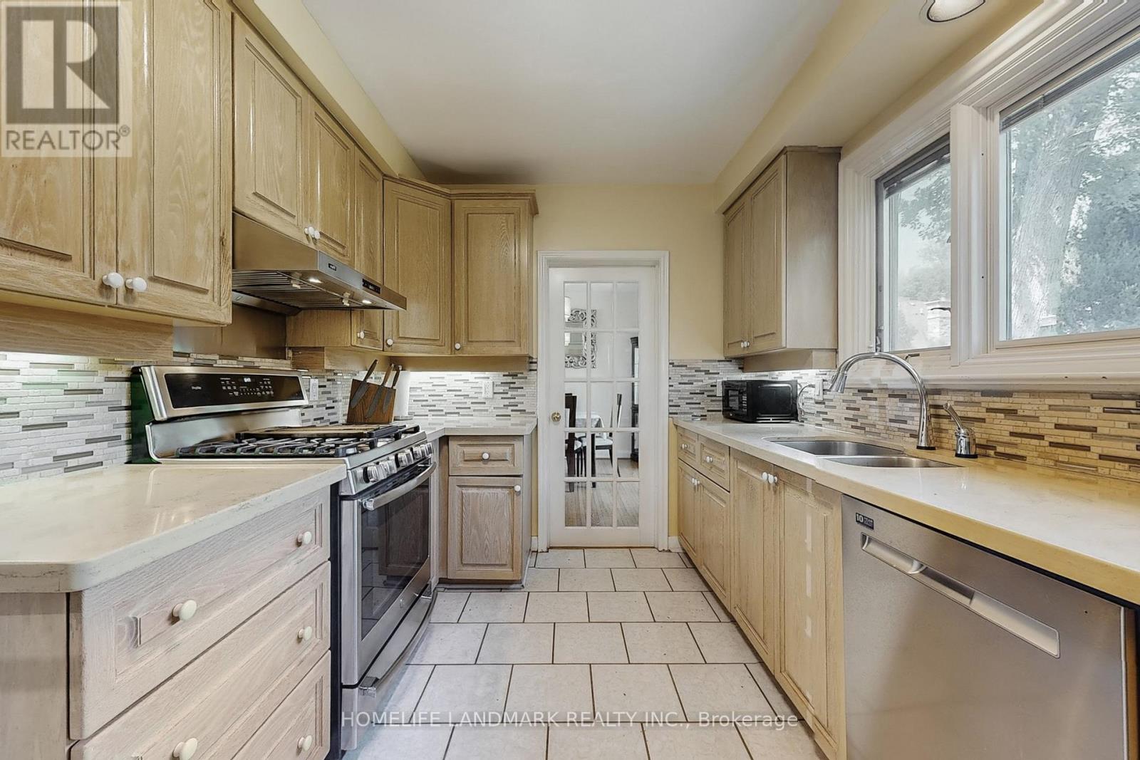A kitchen with wooden cabinets and a stove top oven.