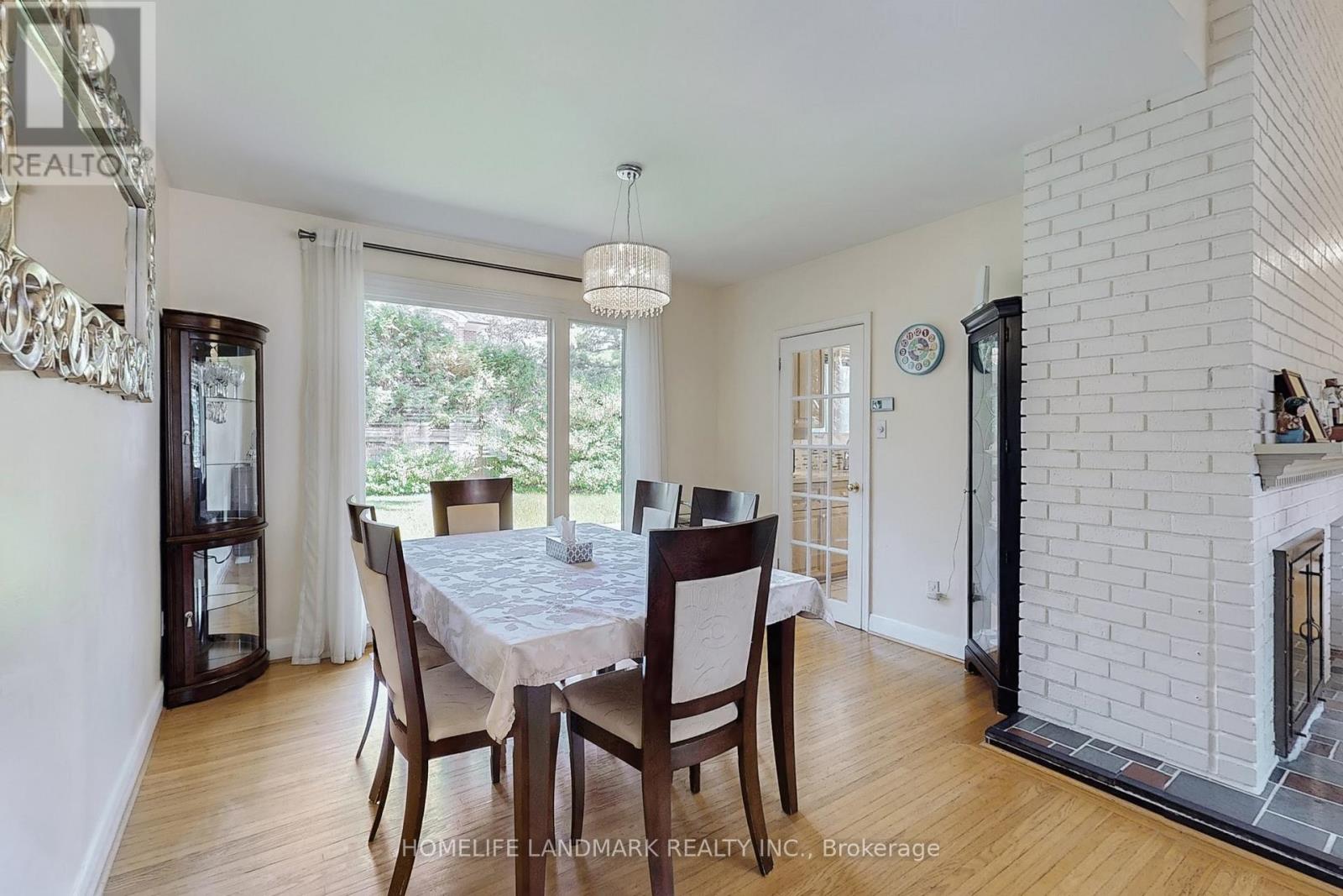A dining room with a table set for four.