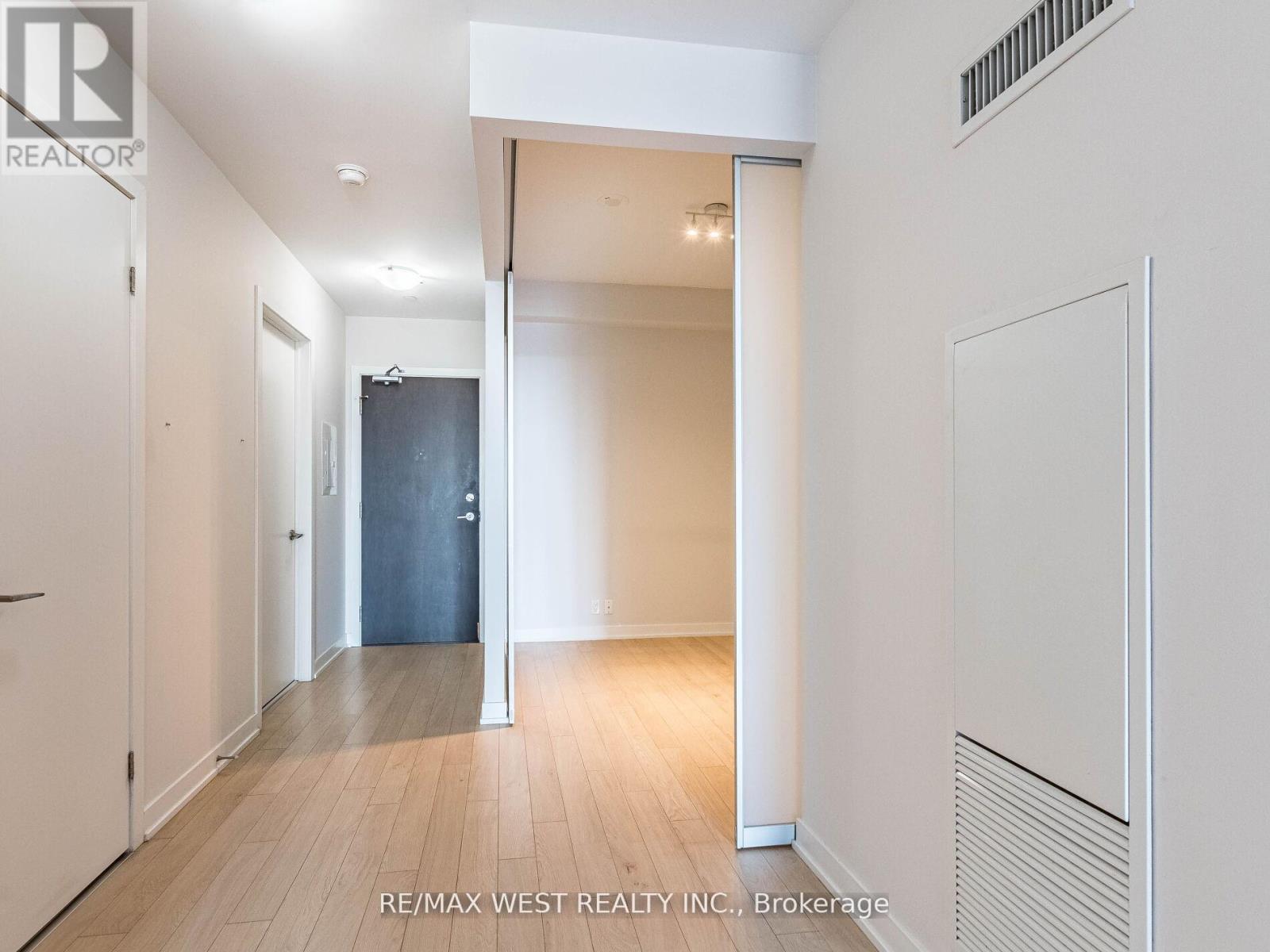 A spacious room with a sliding door and a radiator on the wall.