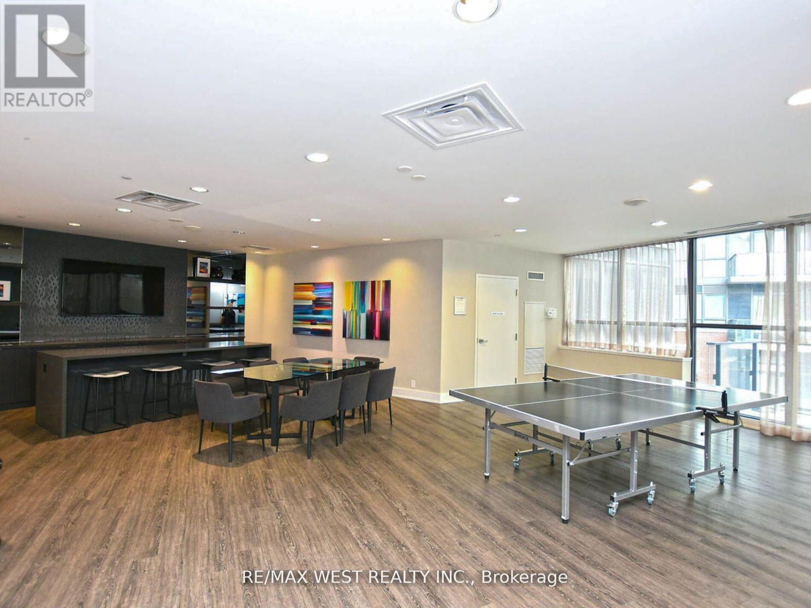 A spacious living room with a dining table and chairs.