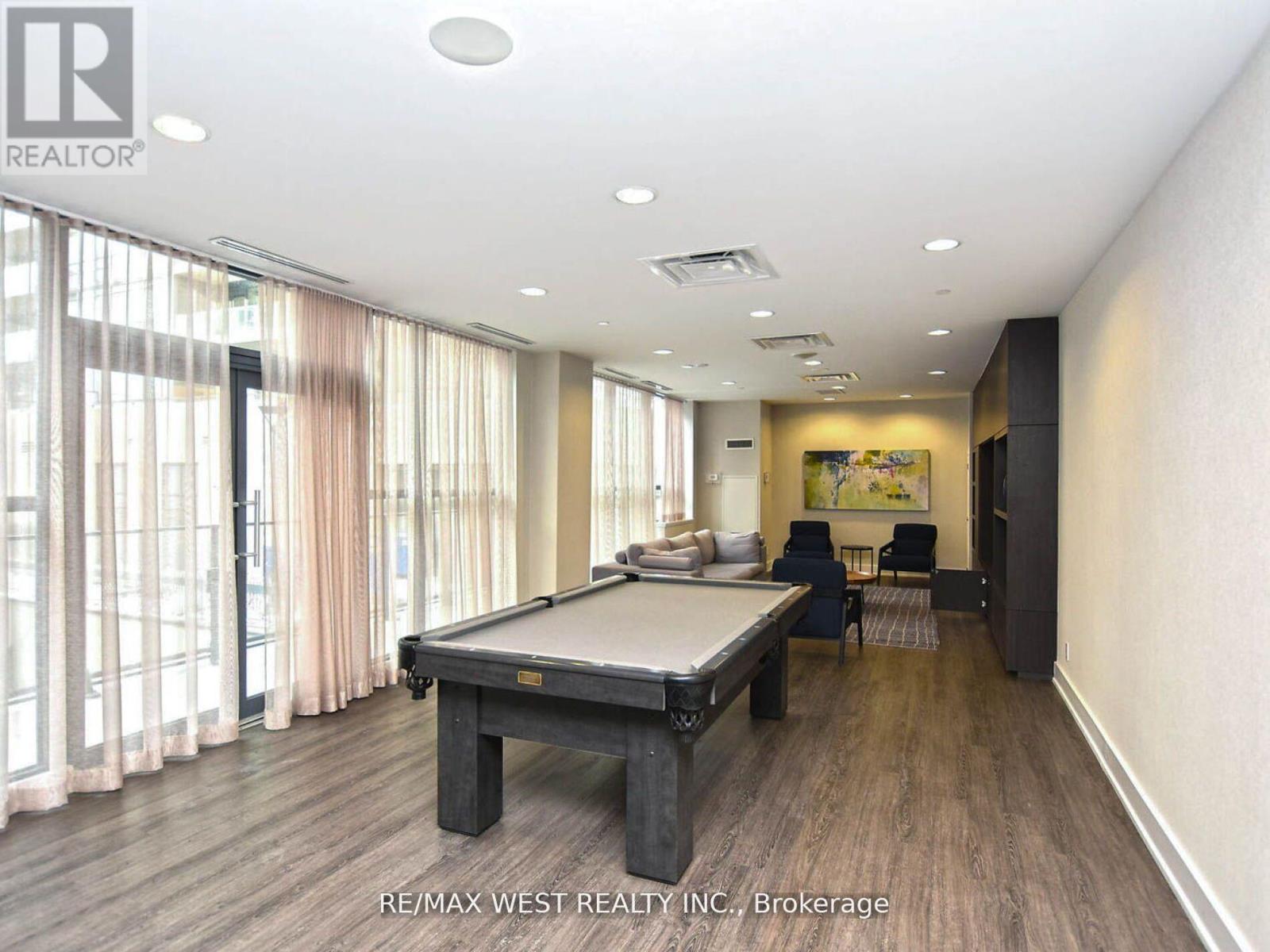 A pool table in a room with a painting on the wall.