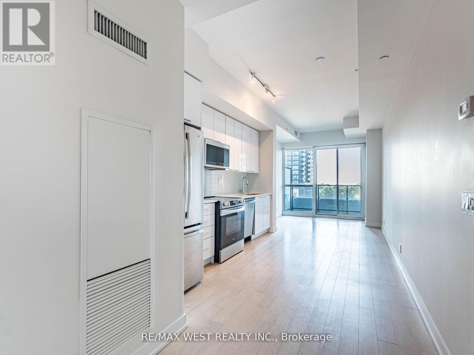 A spacious kitchen with white cabinets and a large island.