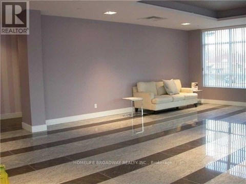 A living room with a white couch and a marble floor.