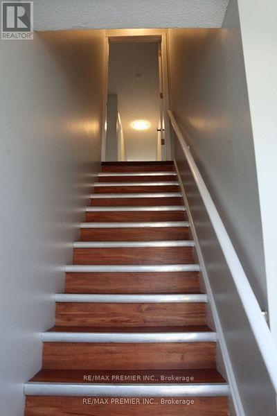 A long flight of wooden stairs leading to a door.