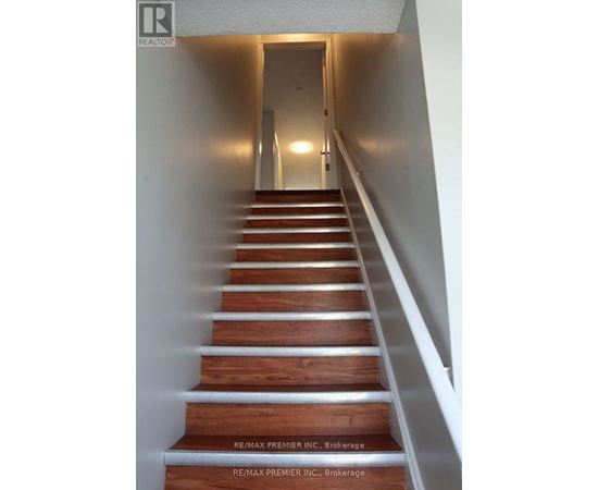A long flight of wooden stairs leading to a door.
