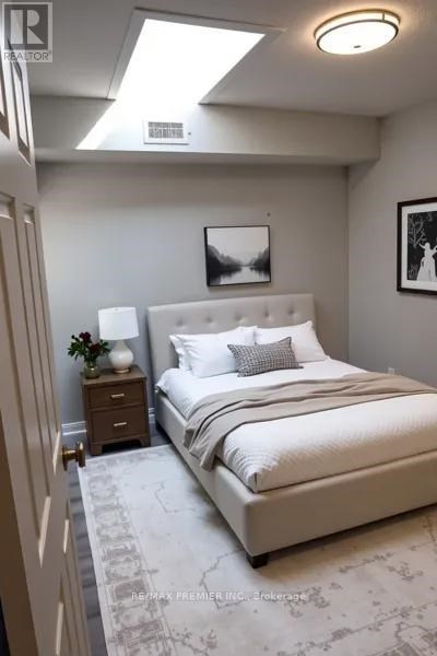 A bedroom with a large bed and a skylight.