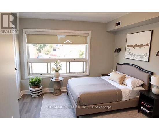 A bedroom with a large bed and a window with a view of the outside.