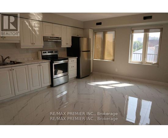 A kitchen with white cabinets and a black stove top oven.